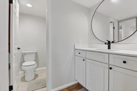 a bathroom with a toilet and a mirror