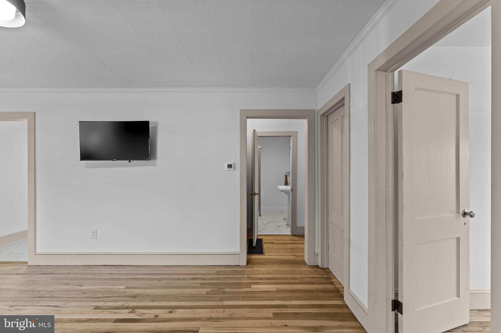 216 Walnut Street Berryville, VA 22611 - Photo 5 of 36 a view of a livingroom with wooden floor and a flat screen tv