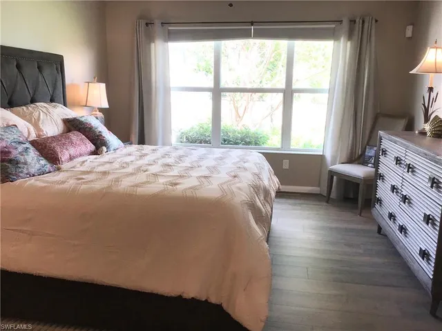 a spacious bedroom with a bed and a window