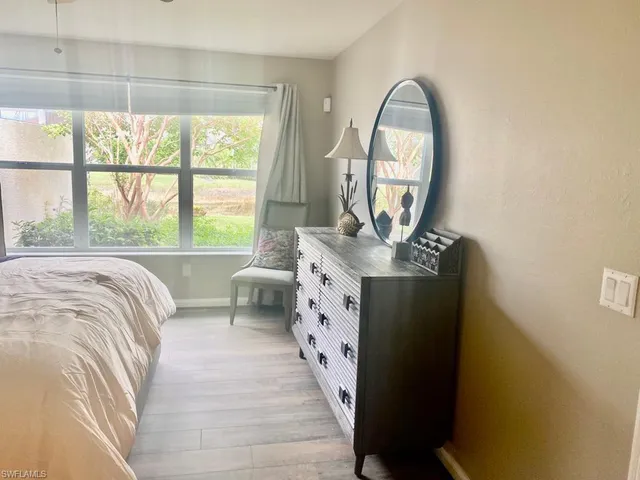 a bed sitting in a bedroom next to a window