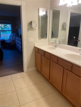 a bathroom with a double vanity sink a mirror and a shower
