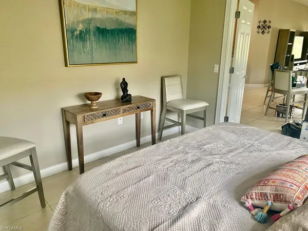 a bedroom with a bed and a chair