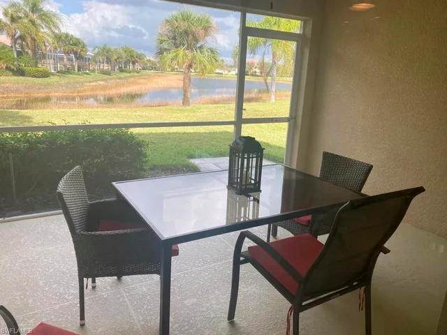 a view of a dining room with furniture and a window
