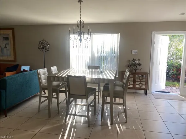 a view of a dining room with furniture and chandelier