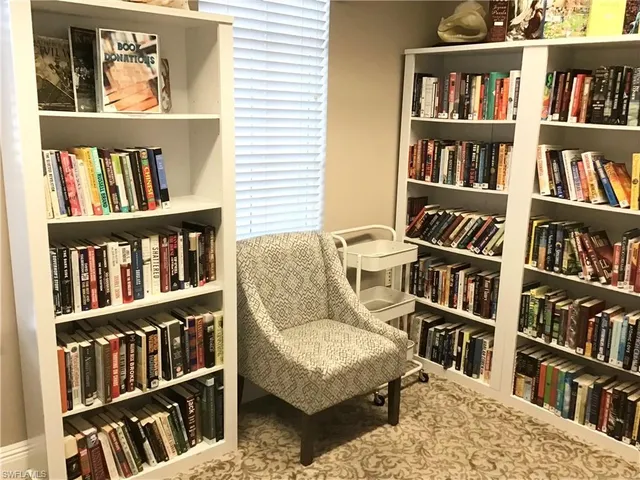 a living room with a book shelf and a book shelf
