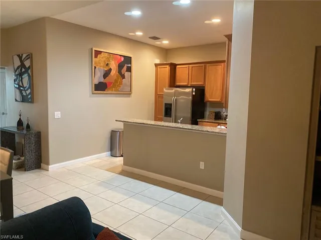 a bedroom with a bed and a large mirror