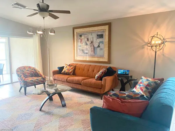 a living room with furniture and a chandelier
