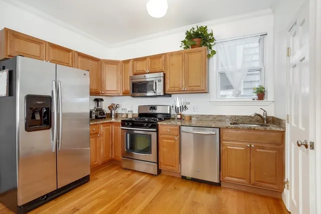 a kitchen with stainless steel appliances granite countertop a refrigerator sink and microwave