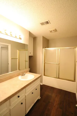 a bathroom with a double vanity sink and mirror