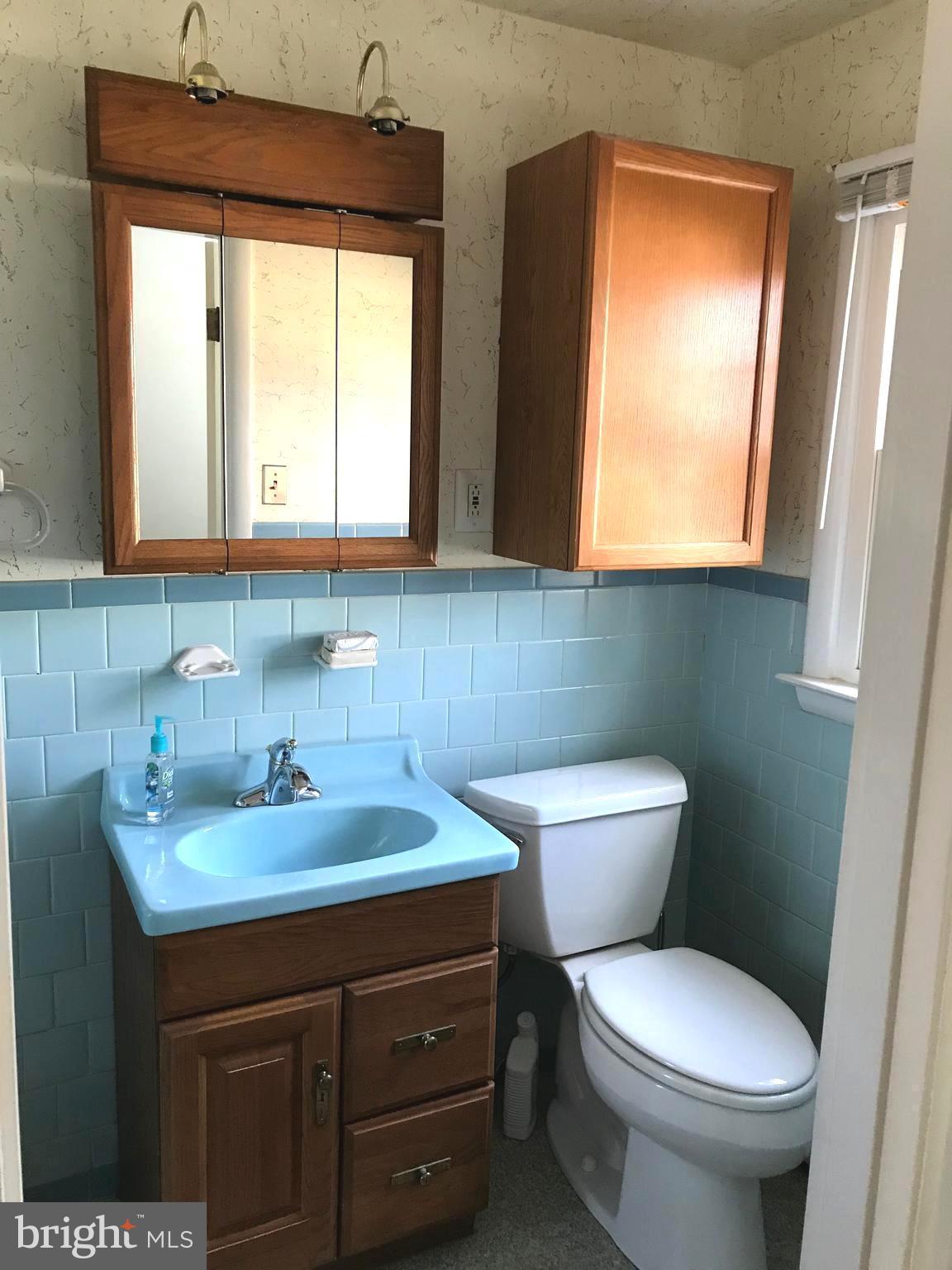 8411 Coco Road Baltimore, MD 21237 - Photo 14 of 23 a bathroom with a toilet sink and mirror
