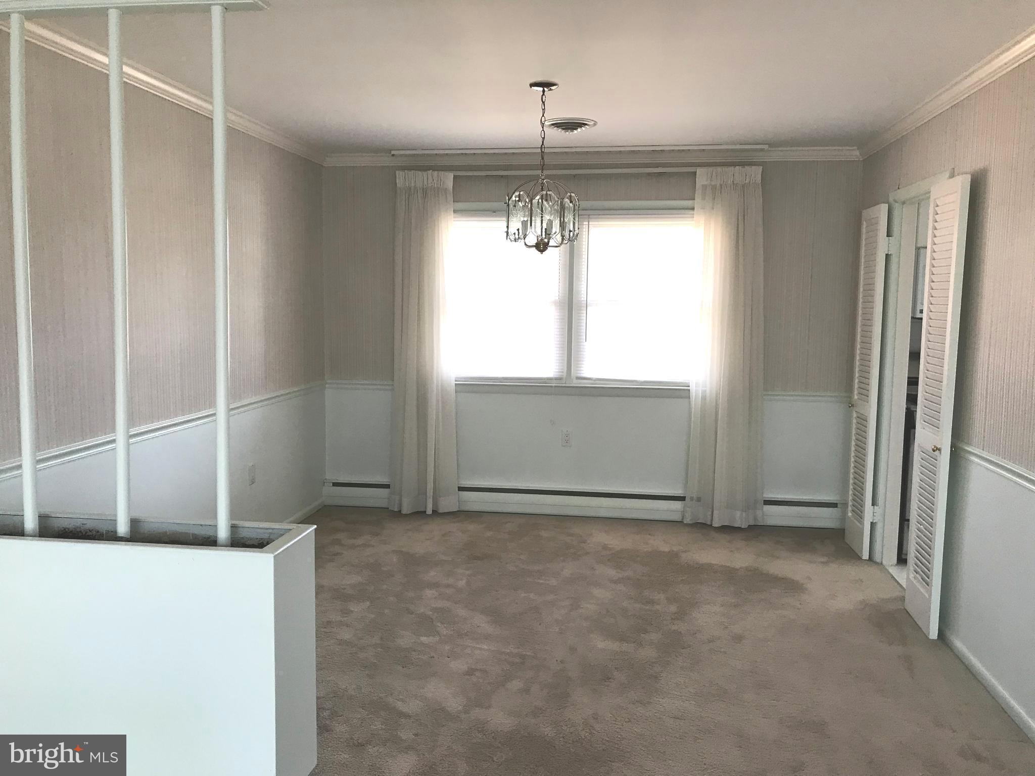 8411 Coco Road Baltimore, MD 21237 - Photo 3 of 23 a view of an empty room with a window