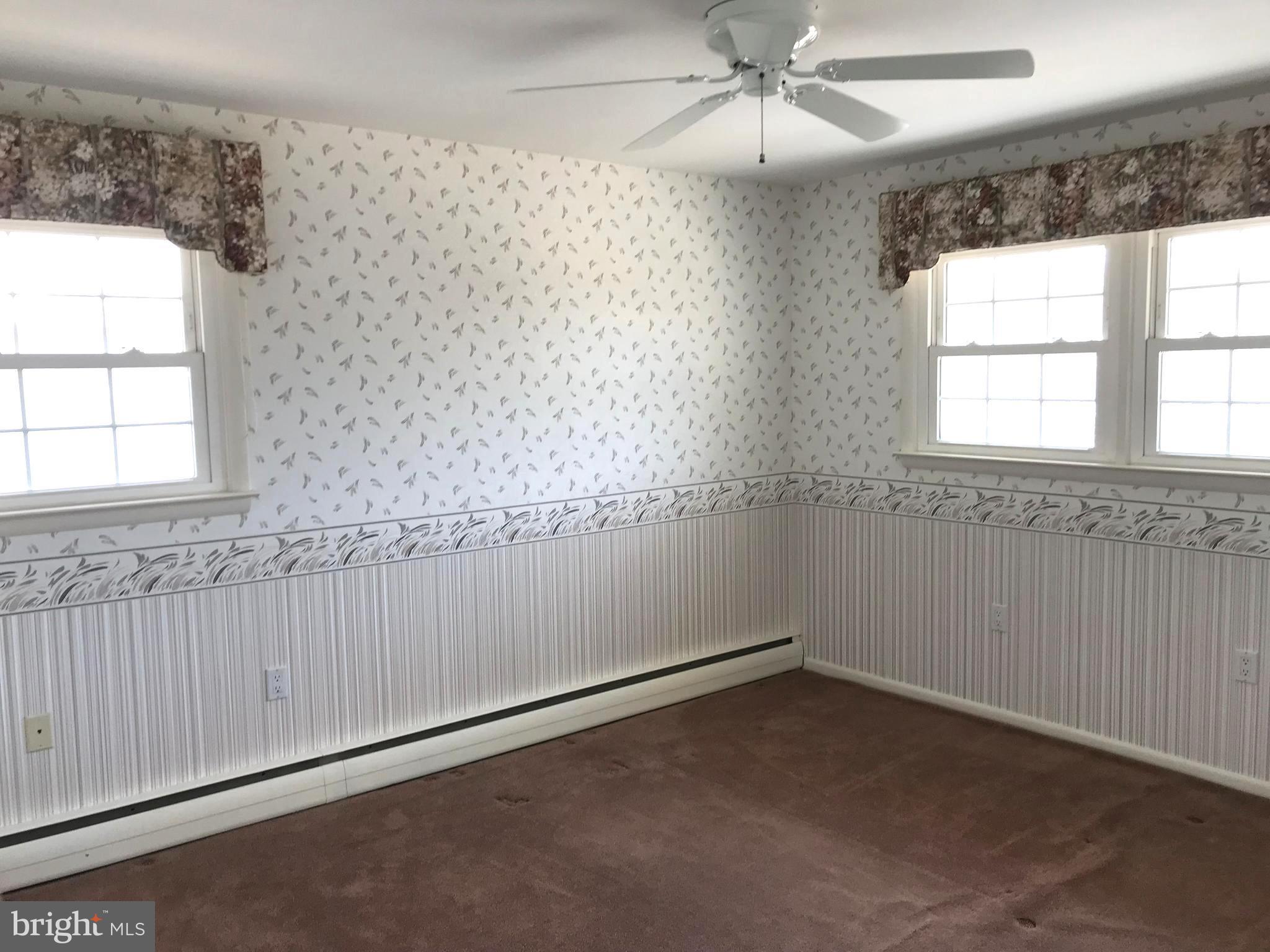 8411 Coco Road Baltimore, MD 21237 - Photo 8 of 23 an empty room with a window and a ceiling fan