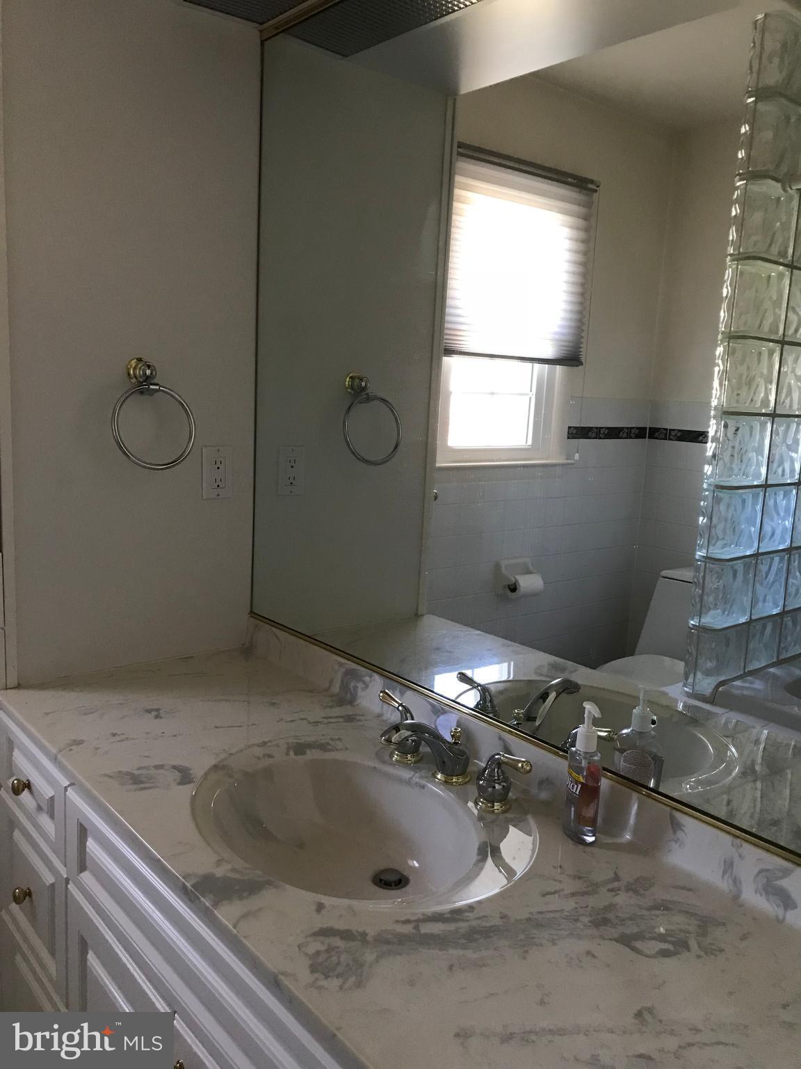 8411 Coco Road Baltimore, MD 21237 - Photo 10 of 23 a bathroom with a sink and mirror