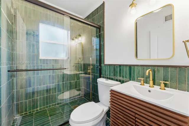 a bathroom with a sink a toilet and mirror