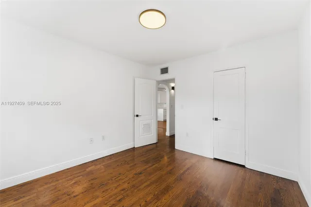 a view of room with wooden floor and window
