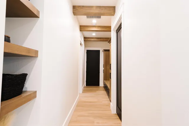 a view of a hallway with wooden floor