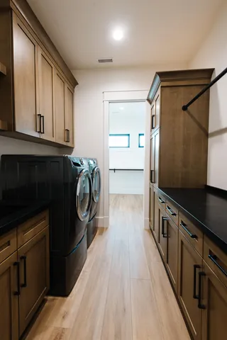 a kitchen with granite countertop a refrigerator a sink and dishwasher