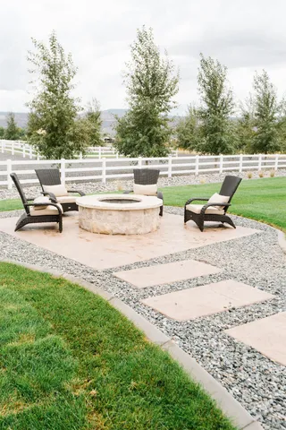 a view of a big house with a big yard and potted plants