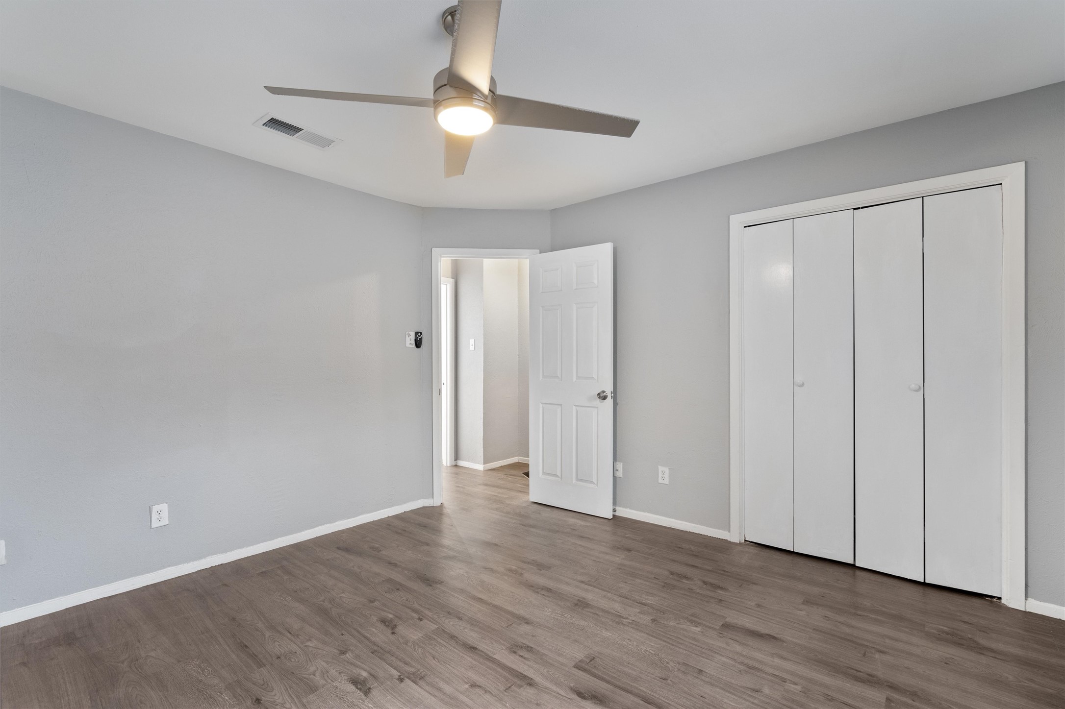 3415 Menchaca Road, Unit 113 Austin, TX 78704 - Photo 12 of 21 a view of an empty room with wooden floor
