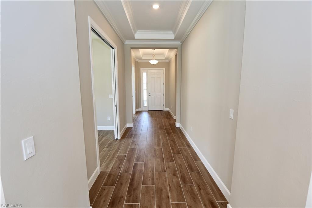 8437 Rosa Court Naples, FL 34114 - Photo 2 of 32 a view of a hallway with wooden floor