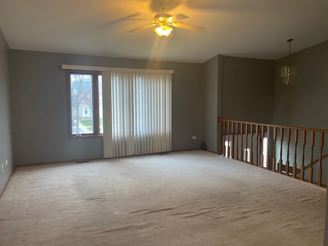 4017 Ridge Road Zion, IL 60099 - Photo 3 of 18 a view of a livingroom with a ceiling fan and window