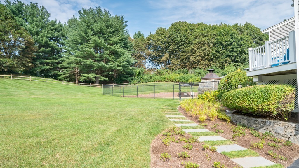 33 Oxbow Road Needham, MA 02492 - Photo 19 of 24 a view of a garden with a bench