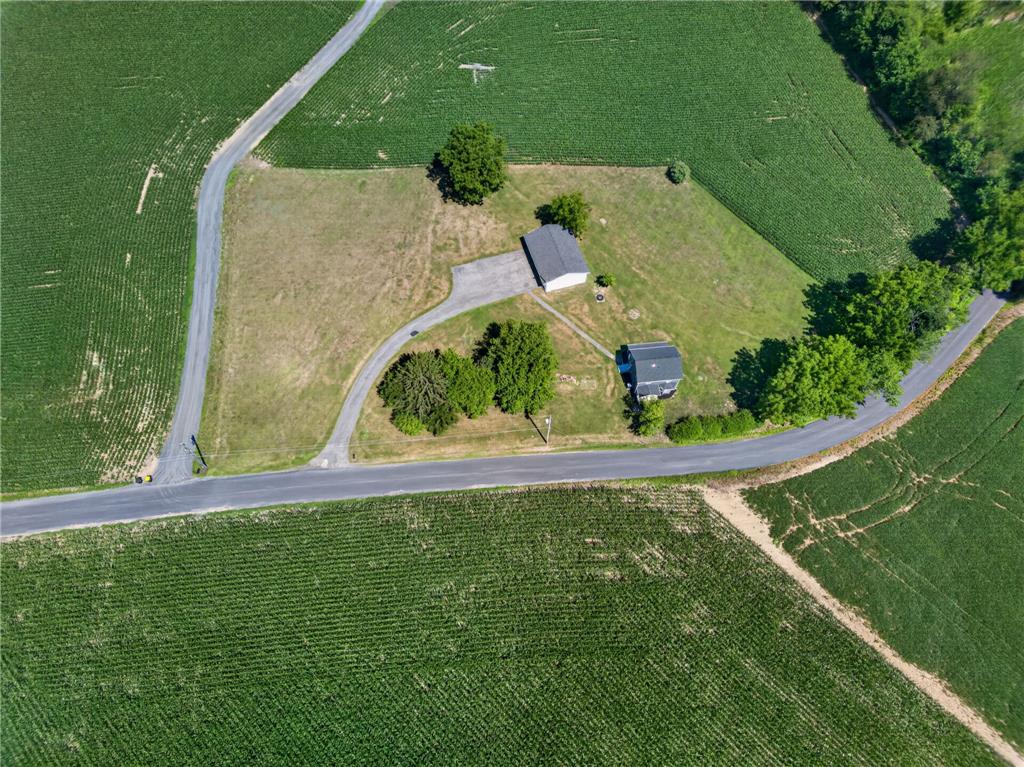 291 East Dannersville Road Bath, PA 18014 - Photo 17 of 46 An aerial perspective reveals a secluded property amidst vast agricultural fields with mature trees and private driveways.