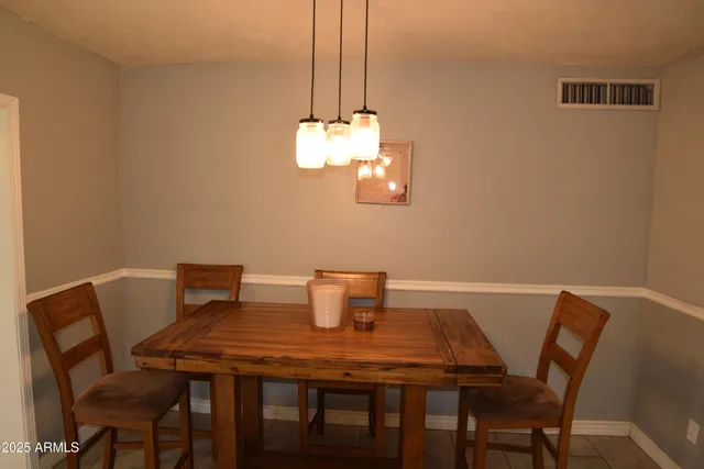 a kitchen with kitchen island granite countertop a refrigerator oven a sink and dishwasher