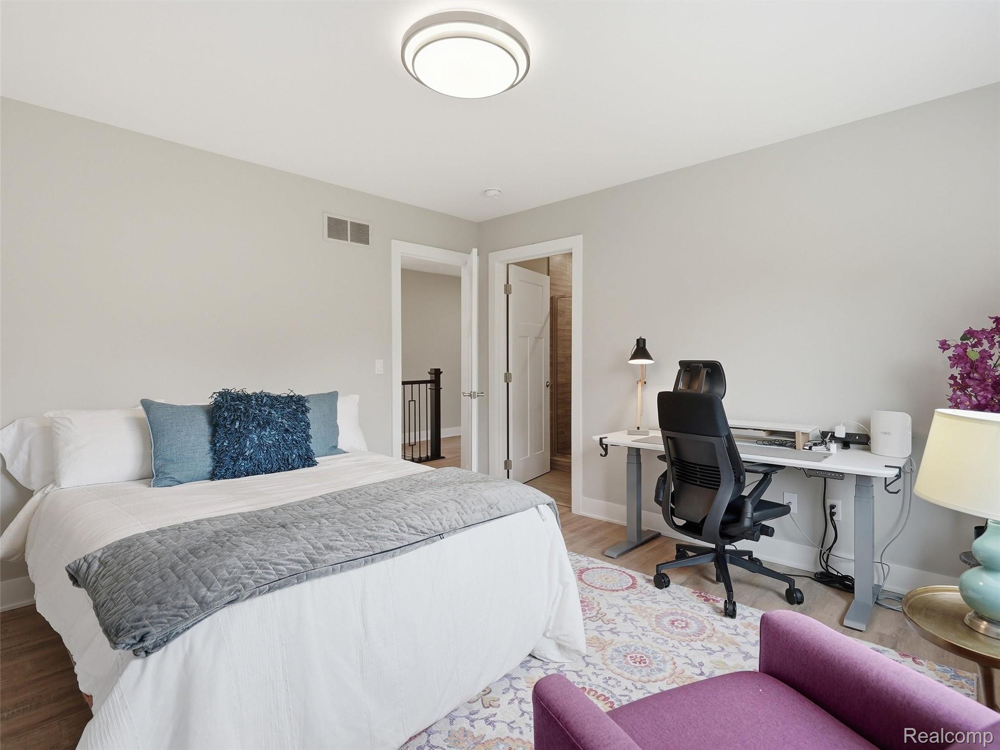 3007 28 Mile Road Washington, MI 48094 - Photo 33 of 69 Bedroom featuring wood-finish flooring, light grey painted walls, a flush-mount ceiling light fixture, and a white interior door