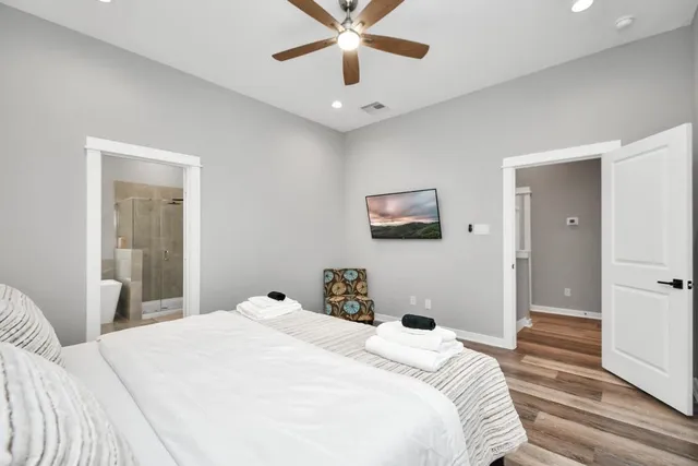 a bedroom with a large bed and a chandelier