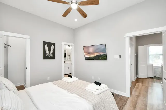a bedroom with a bed and wooden floor