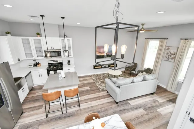 a living room with furniture and a chandelier
