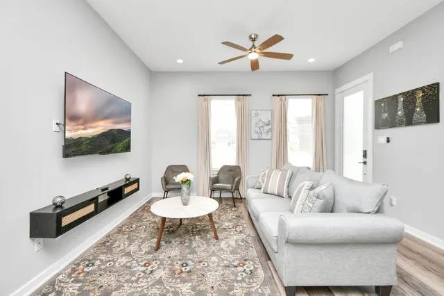 a living room with furniture and a flat screen tv