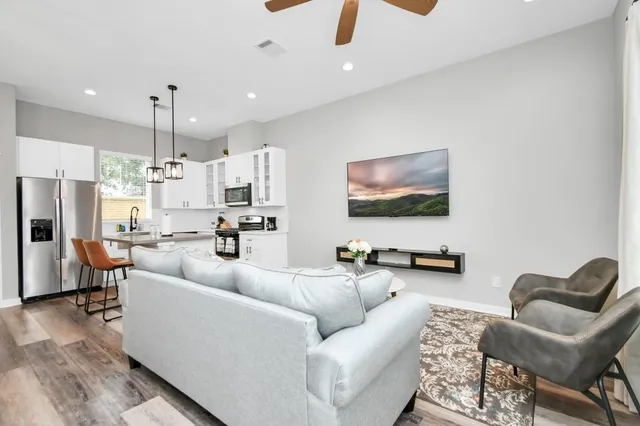 a living room with furniture and kitchen view