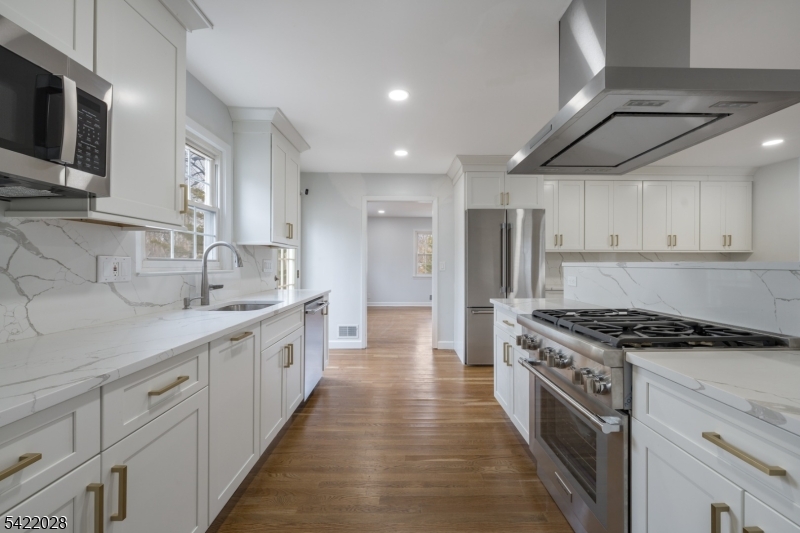 6 Windsor Way Berkeley Heights, NJ 07922 - Photo 16 of 36 a large kitchen with stainless steel appliances granite countertop a stove a sink and a microwave
