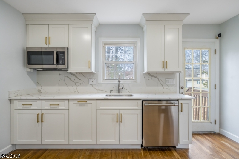 6 Windsor Way Berkeley Heights, NJ 07922 - Photo 18 of 36 a kitchen with stainless steel appliances granite countertop a stove a sink and white cabinets