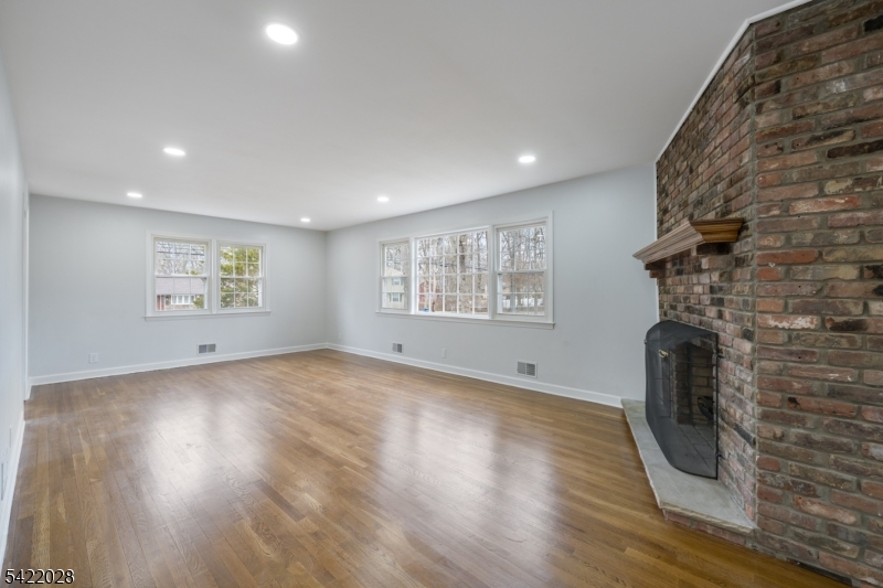 6 Windsor Way Berkeley Heights, NJ 07922 - Photo 19 of 36 an empty room with wooden floor and windows