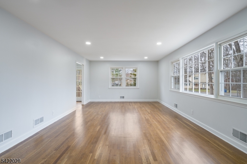 6 Windsor Way Berkeley Heights, NJ 07922 - Photo 20 of 36 an empty room with wooden floor and windows