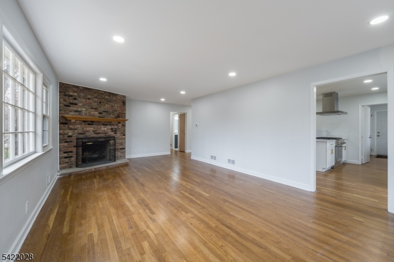 6 Windsor Way Berkeley Heights, NJ 07922 - Photo 22 of 36 a view of a livingroom with a fireplace a ceiling fan and window