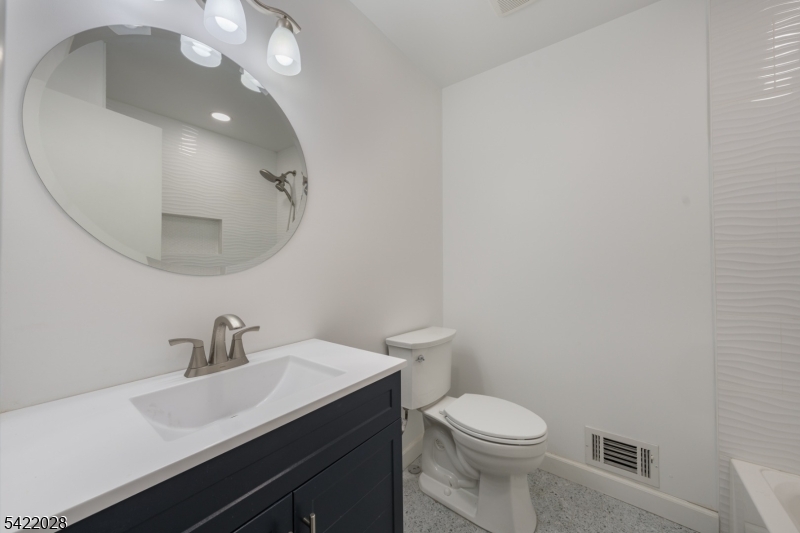 6 Windsor Way Berkeley Heights, NJ 07922 - Photo 23 of 36 a bathroom with a toilet a sink and mirror