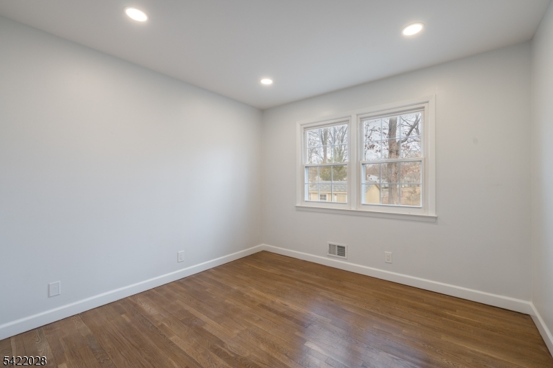 6 Windsor Way Berkeley Heights, NJ 07922 - Photo 24 of 36 an empty room with wooden floor and windows