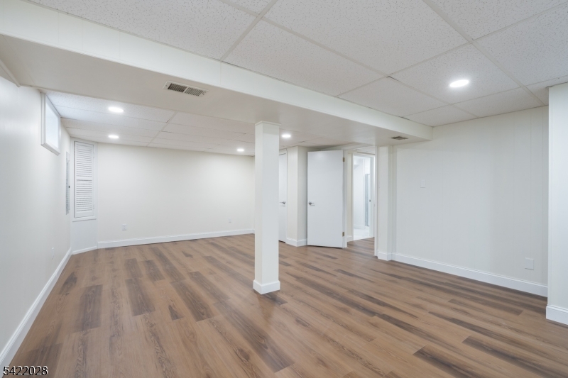 6 Windsor Way Berkeley Heights, NJ 07922 - Photo 35 of 36 a view of an empty room with wooden floor