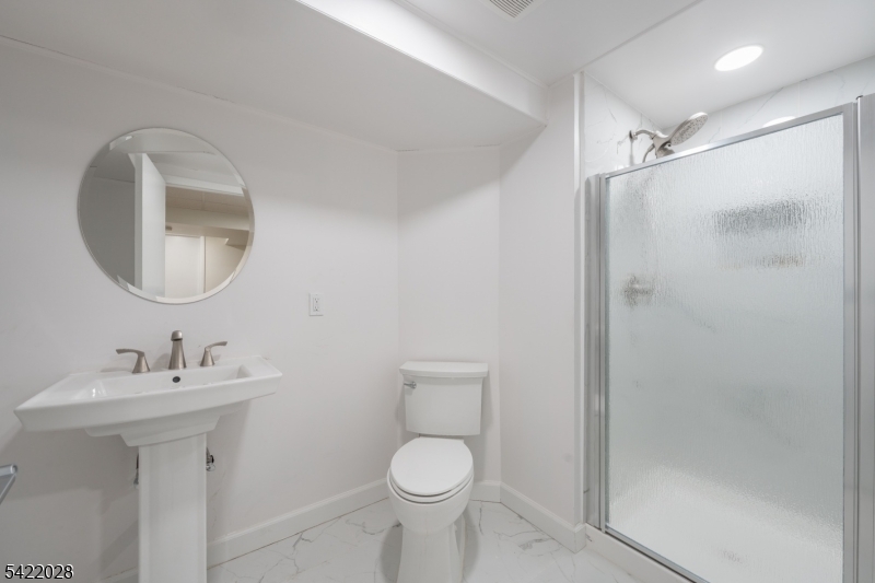 6 Windsor Way Berkeley Heights, NJ 07922 - Photo 36 of 36 a bathroom with a toilet sink and mirror