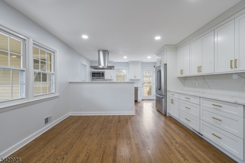 6 Windsor Way Berkeley Heights, NJ 07922 - Photo 10 of 36 a kitchen with wooden floors and white cabinets