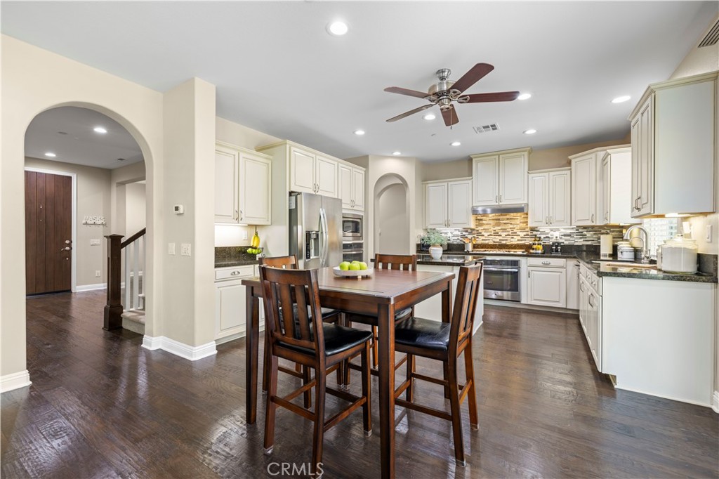 28319 Chisel Court Valencia, CA 91354 - Photo 14 of 74 a kitchen with stainless steel appliances granite countertop a dining table chairs refrigerator and microwave