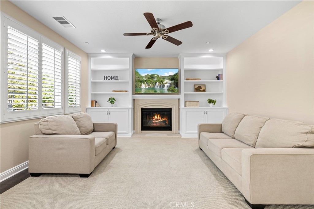 28319 Chisel Court Valencia, CA 91354 - Photo 16 of 74 a living room with furniture a fireplace and a large window