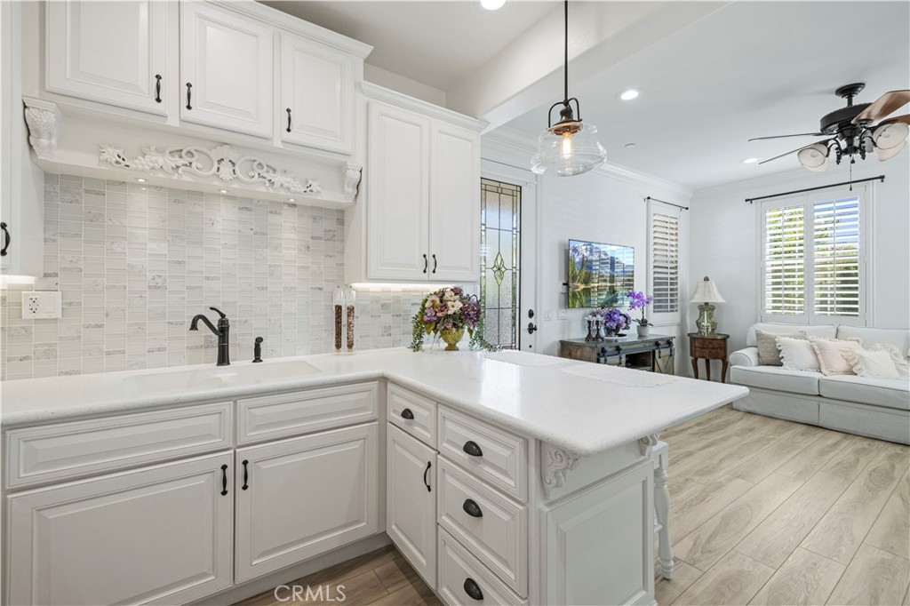 28319 Chisel Court Valencia, CA 91354 - Photo 43 of 74 a kitchen with sink cabinets and living room view