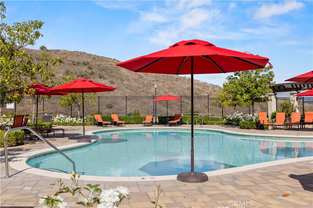28319 Chisel Court Valencia, CA 91354 - Photo 66 of 74 a view of water with a terrace dining table and chairs under an umbrella