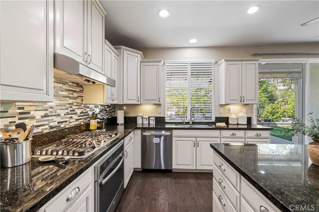 28319 Chisel Court Valencia, CA 91354 - Photo 10 of 74 a kitchen with stainless steel appliances granite countertop a sink stove cabinets and wooden floor