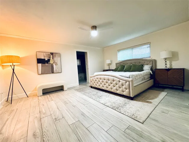 a bedroom with a bed and a night stand
